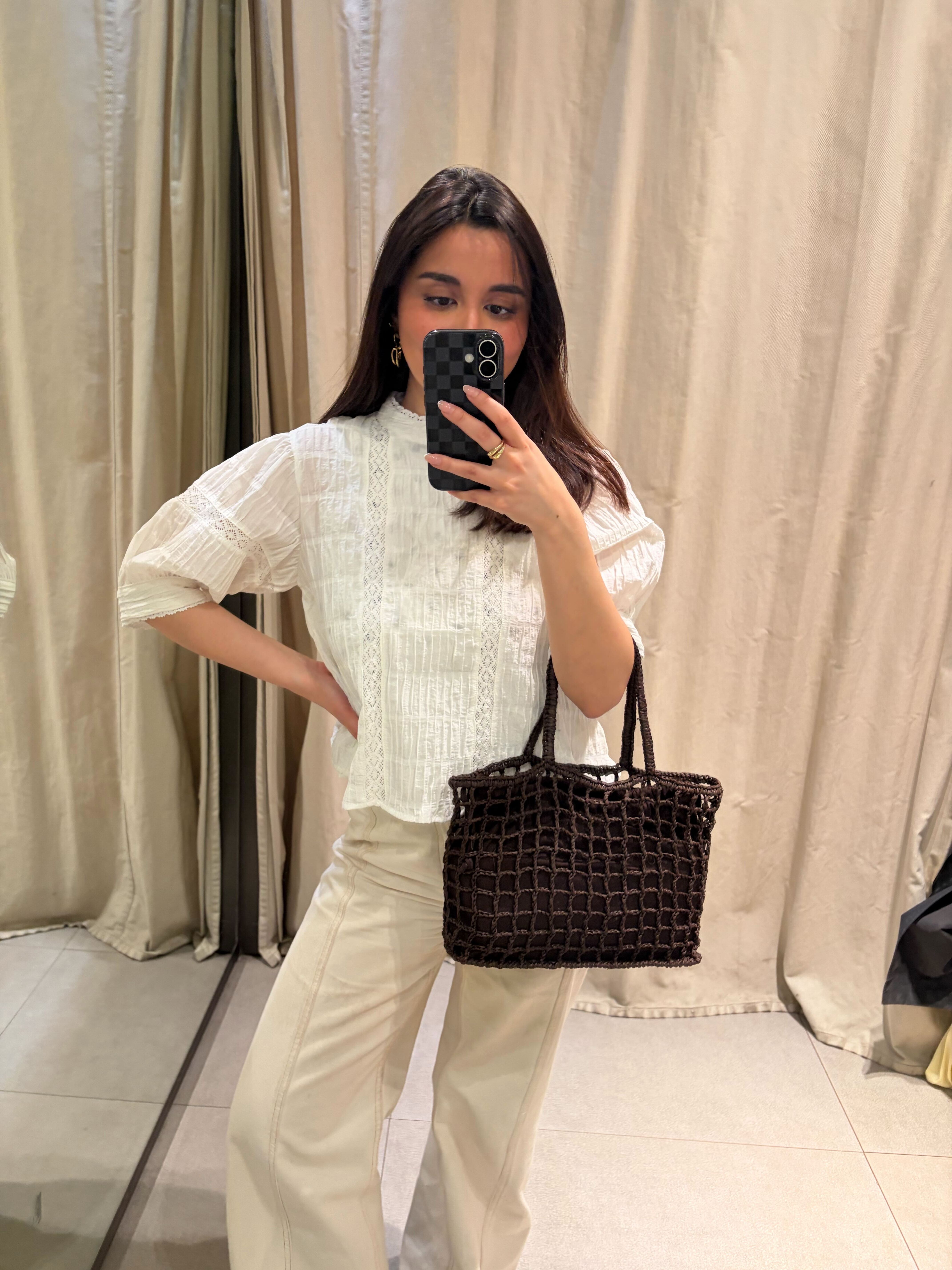 Marina wearing blouse and jeans