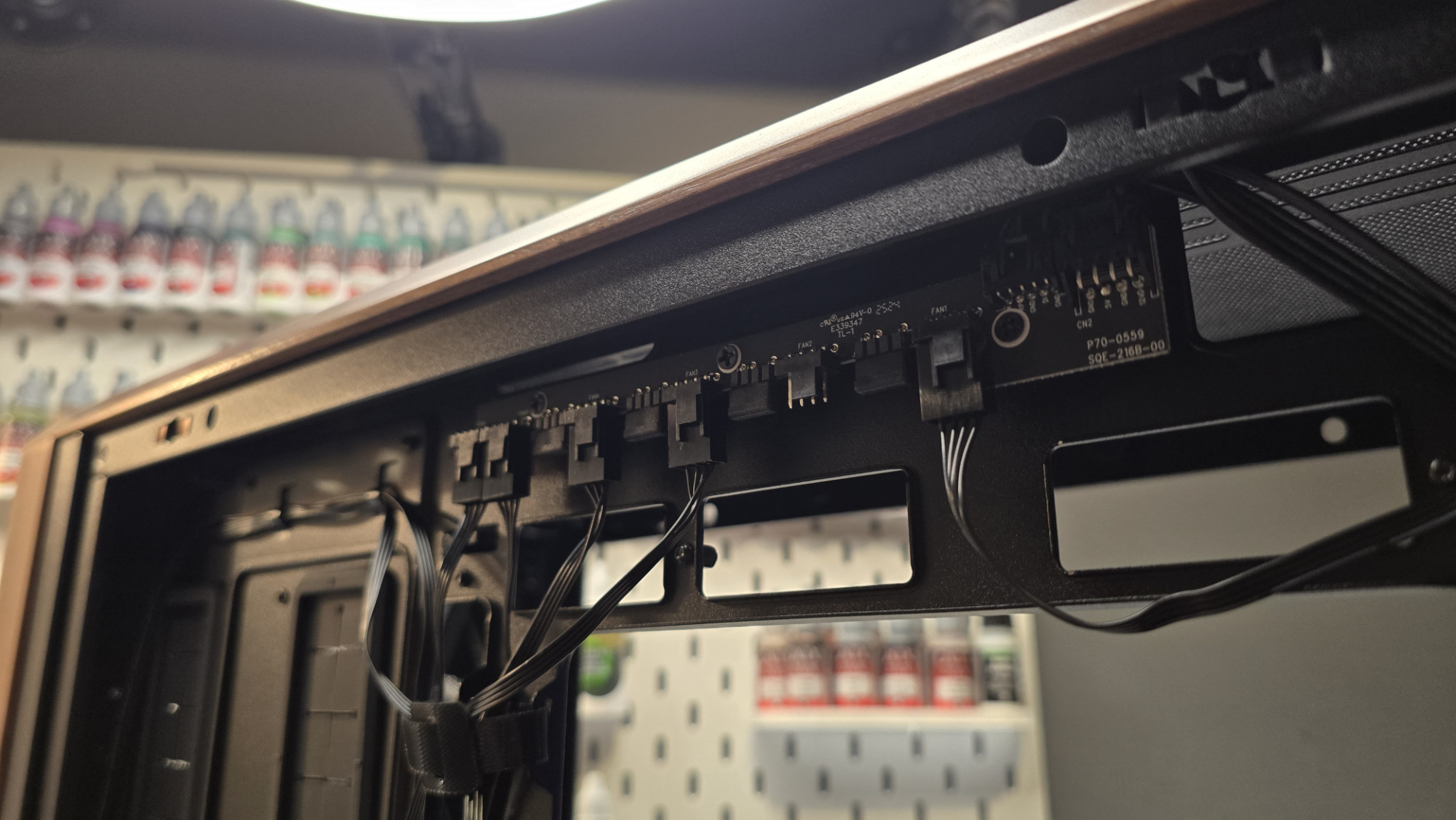 A Lian Li Lancool 217 on a desk with various components installed inside it.