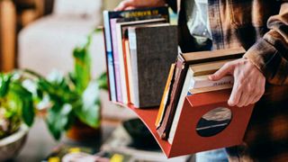 A red metal bookend from IKEA filled with books