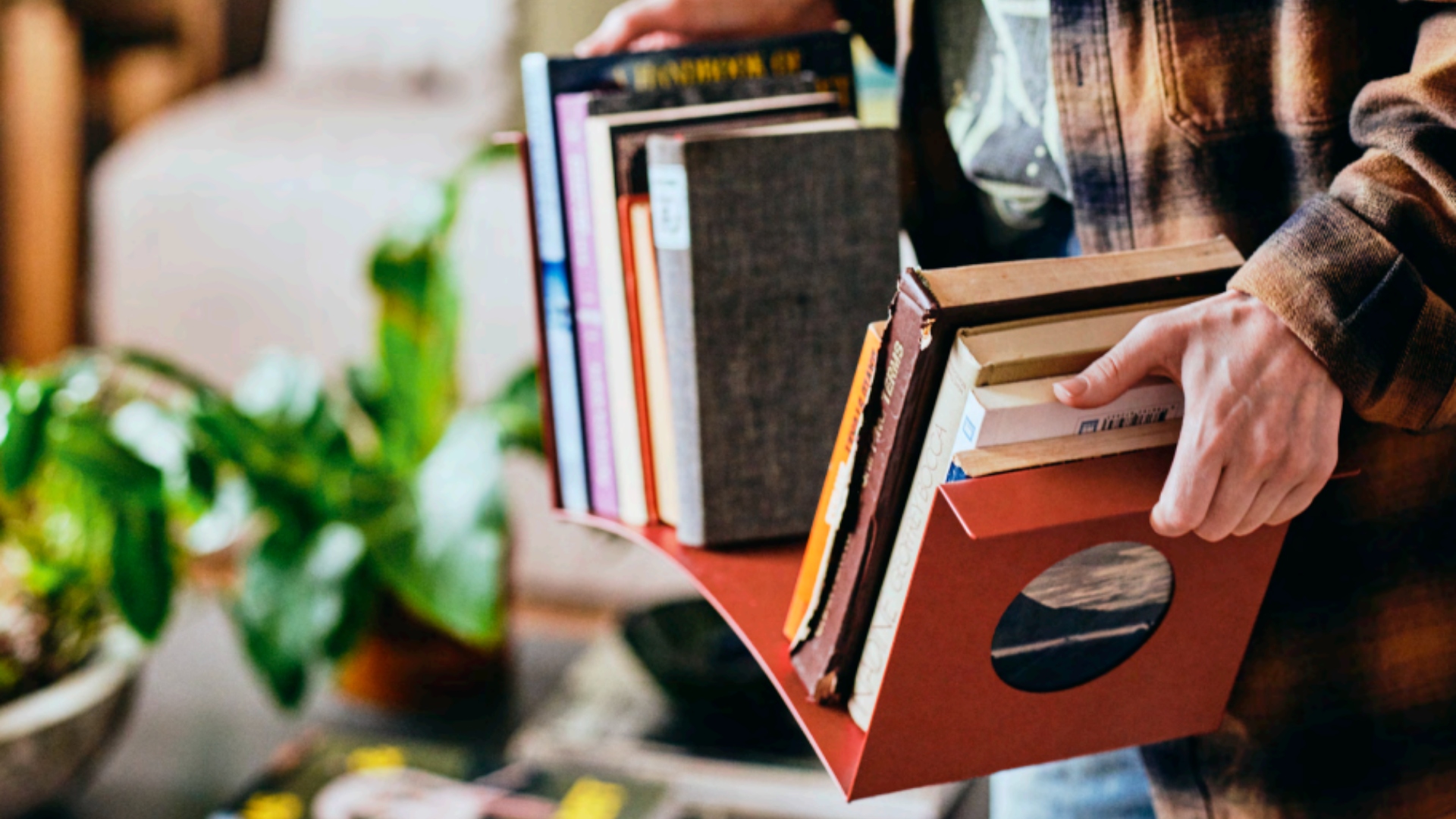 A red metal bookend from IKEA filled with books