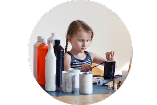 A child making a tin can wind chime