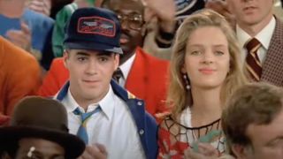 Robert Downey Jr. and Uma Thurman sit together during a pep rally in Johnny Be Good.