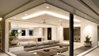Contemporary living space with sunken seating illuminated by LED down lighting