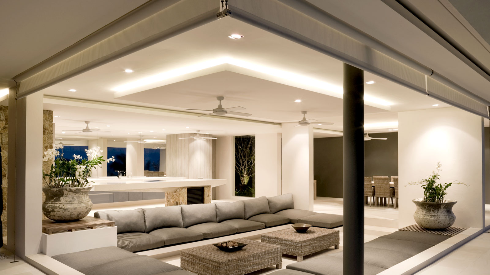 Contemporary living space with sunken seating illuminated by LED down lighting