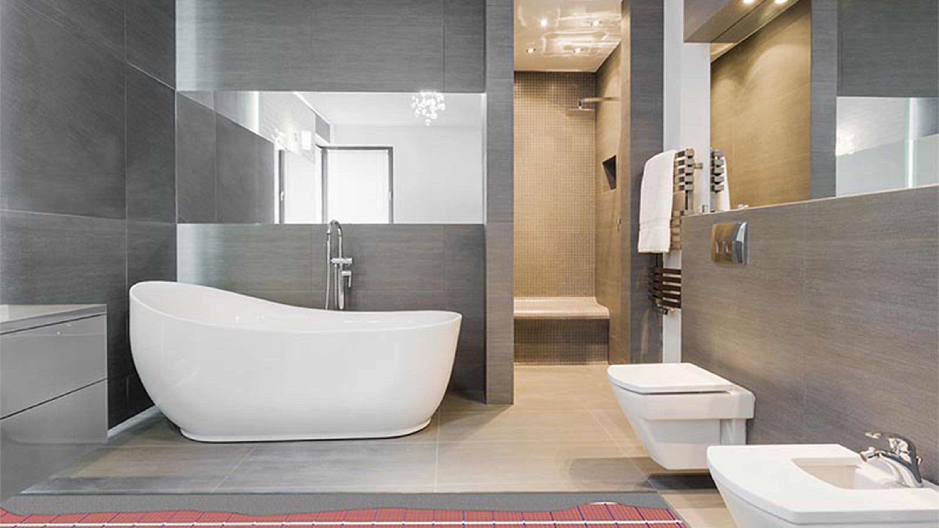 White and grey luxury bathroom suite with bathtub, shower, mirror and underfloor heating