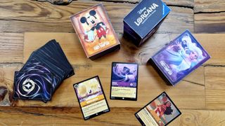 Disney Lorcana cards and boxes on a wooden table