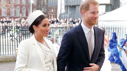Prince Harry and Meghan Markle walk next to one another