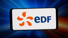 The EDF logo shown on a smartphone in front of an abstract background of beams of light.
