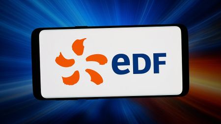 The EDF logo shown on a smartphone in front of an abstract background of beams of light.