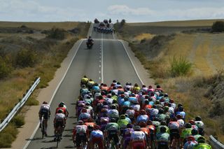 The peloton chasing a large leading group in the crosswinds on stage 17 of the Vuelta a Espana