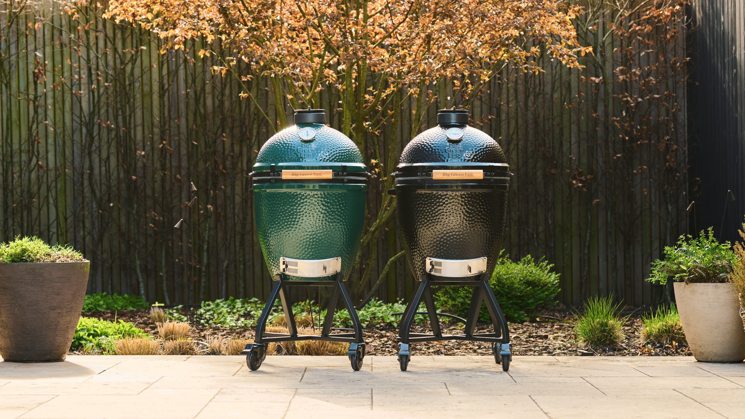 Big Green Egg and Big Onyx Egg on patio.