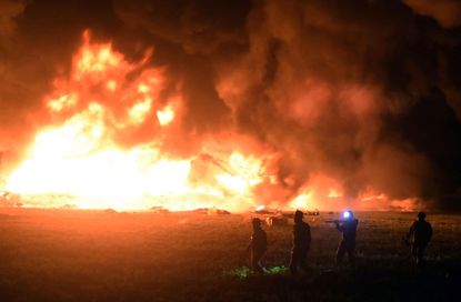 Flames burn at the scene of a massive blaze trigerred by a leaky pipeline in Tlahuelilpan, Hidalgo state, on January 18, 2019.