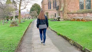 Woman walking in a park from behind