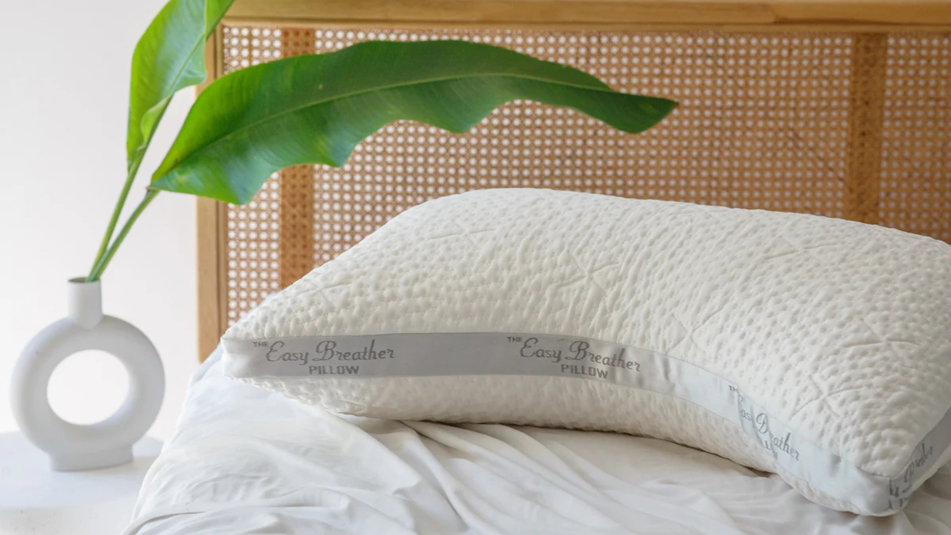 Nest Bedding Easy Breather Side Sleeper Pillow on the bed in a brightly lit room