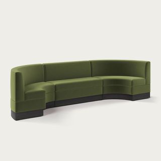 A green velvet curved banquette seat 