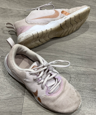 A dirty pair of pastel purple sneakers