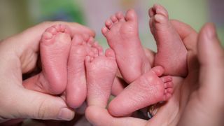 three pairs of feet belonging to triplets