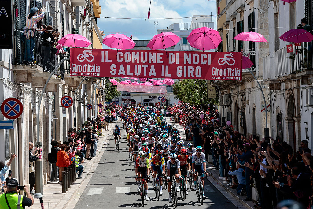 The pack rides through the village of Noci during the 4th stage of the 108th Giro d'Italia cycling race 189kms from Alberobello to Lecce on May 13, 2025. (Photo by Luca Bettini / AFP)