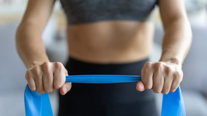 Woman gripping a resistance band
