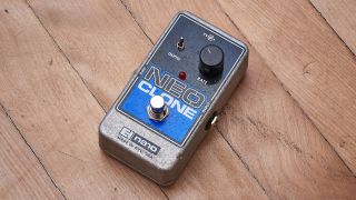 An Electro-Harmonix Neo Clone on a wooden floor