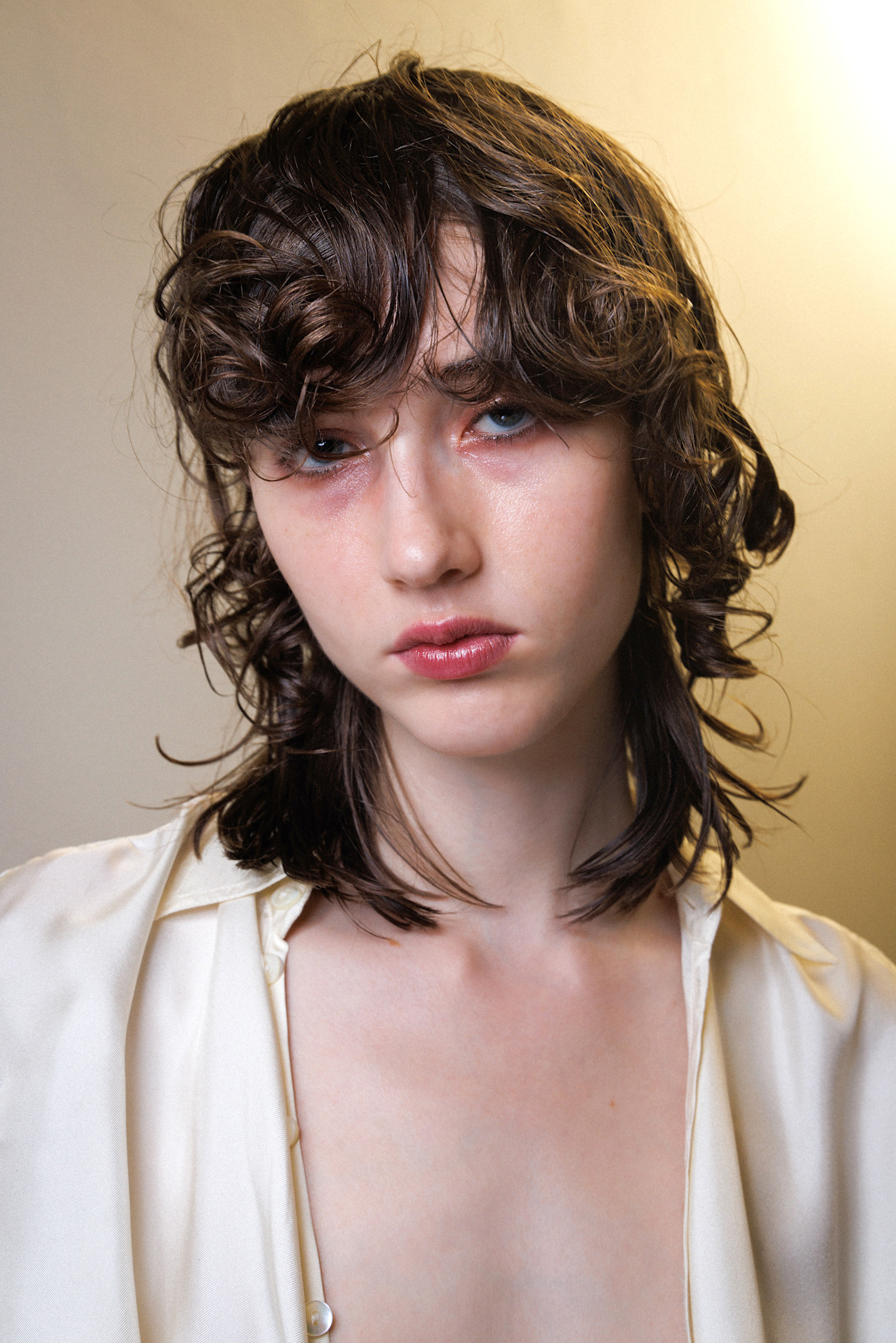 A model wearing their hair in a shag haircut.