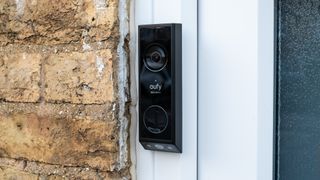 Eufy Video Doorbell E340 installed beside a front door