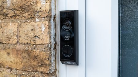 Eufy Video Doorbell E340 installed beside a front door
