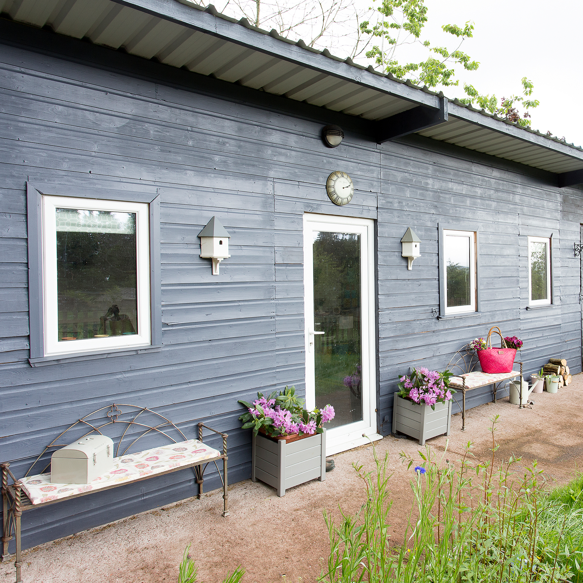 Blue bungalow with white window frames