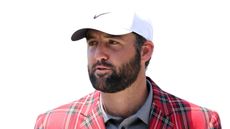 Scottie Scheffler looks on while wearing his tartan champions RBC Heritage jacket and a white Nike cap