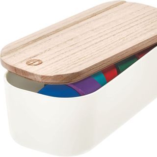 A recycled plastic storage bin with wood lid