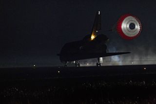 Xenon lights illuminate space shuttle Endeavour's unfurled drag chute as the vehicle rolls to a stop on the Shuttle Landing Facility's Runway 15 at NASA's Kennedy Space Center in Florida for the final time. Main gear touchdown was at 2:34:51 a.m. EDT on June 1, 2011 to end the STS-134 shuttle mission.