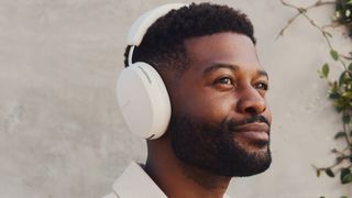 Sonos Ace headphones worn by a man outdoors