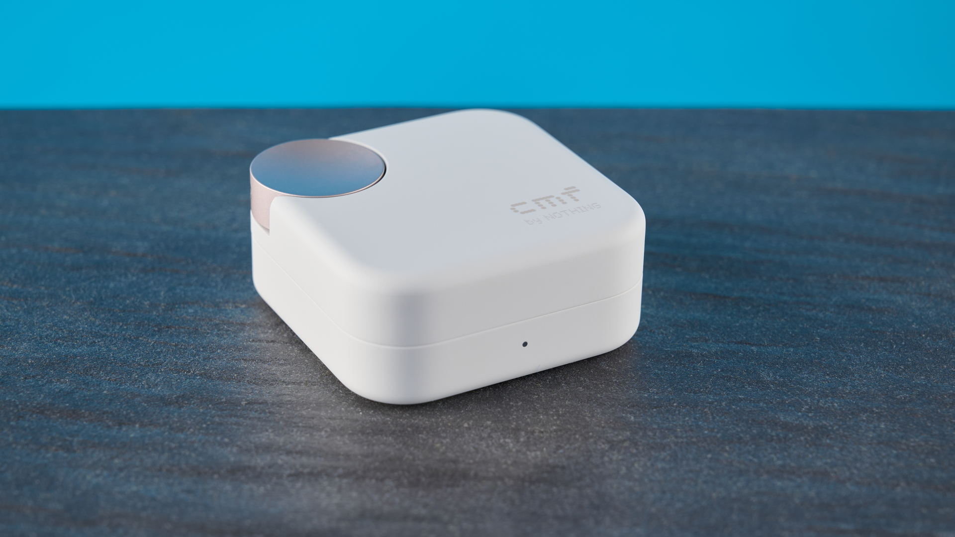 CMF Buds 2 Plus in light gray photographed in front of a blue background