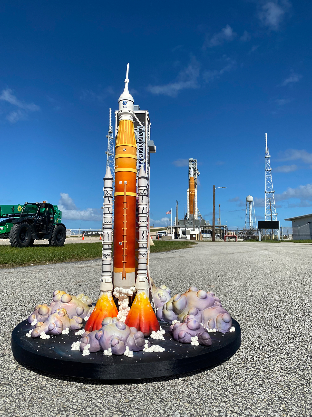 Duff Goldman's Space Launch System (SLS)-shaped cake stands before its inspiration on launchpad 39B at NASA's Kennedy Space Center in Florida.