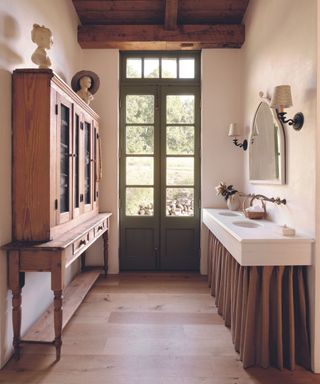 bathroom with double vanity with skirt and freestanding cabinet
