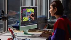 Apple iMac M6 model being used by female designer