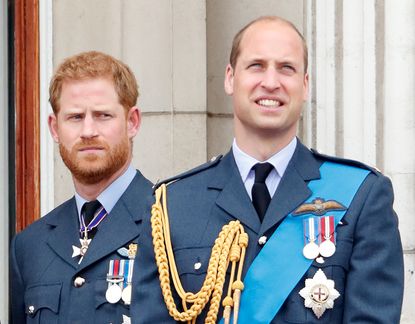 Prince Harry, Duke of Sussex and Prince William, Duke of Cambridge watch a flypast to mark the centenary of the Royal Air Force