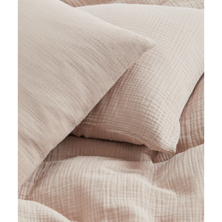beige duvet and pillows with a soft muslin fabric