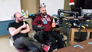 Patient Erik G. Sorto operates a prosthetic arm that interfaces with his brain signals.