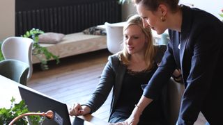 Two women looking at laptop