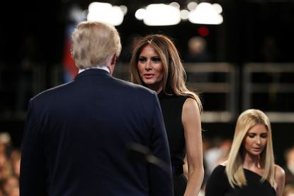 Melania Trump speaks to her husband before the debate.