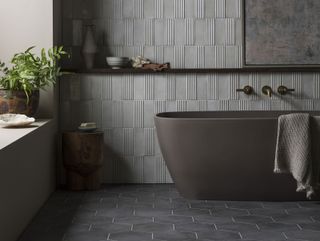 a grey bathroom with a grey bath