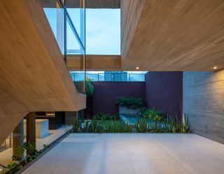 Exposed concrete at Casa Floresta by Estúdio Zargos, a Belo Horizonte home with a radical transformation