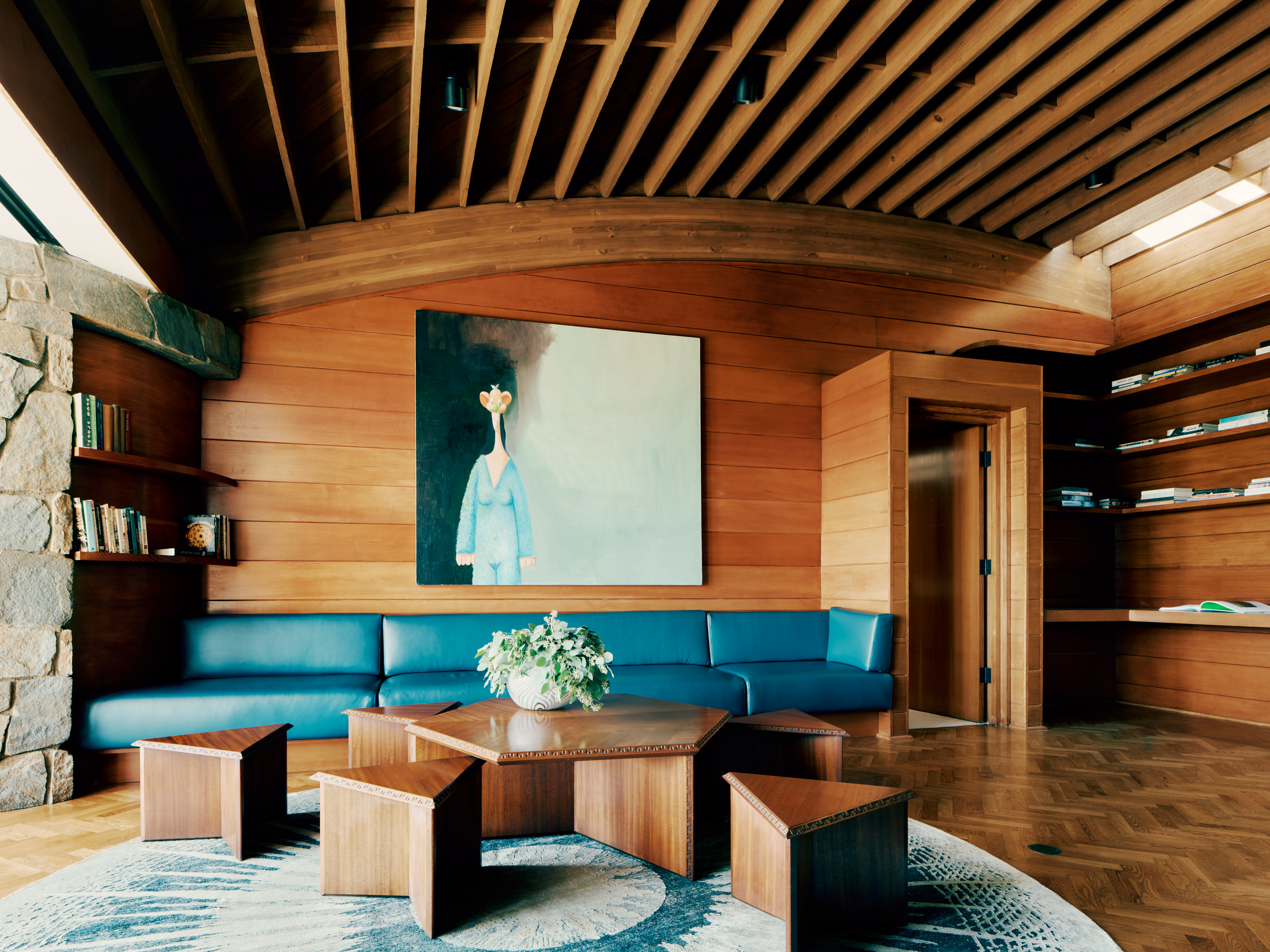 view of Lautner's Castle, a midcentury modernist house refreshed for the present day, showcasing arched timber, and stone and wood surfaces among greenery