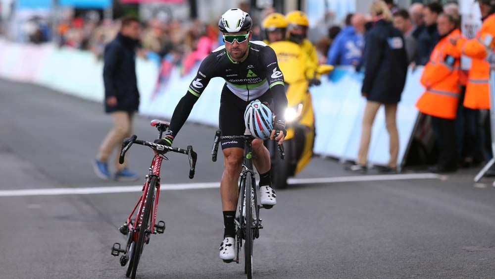 Bernhard Eisel takes Marco Haller's bike back to the Katusha-Alpecin bus