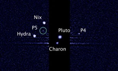 An image taken by NASA's Hubble Space Telescope shows five moons orbiting the distant, icy dwarf planet Pluto: The green circle marks the newly discovered moon, designated P5.