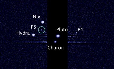 An image taken by NASA&amp;#039;s Hubble Space Telescope shows five moons orbiting the distant, icy dwarf planet Pluto: The green circle marks the newly discovered moon, designated P5.