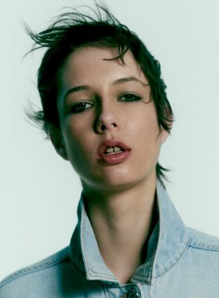 Close up of woman’s face wearing in Jacob Cohen by Matthew Adams Dolan denim jeans and jacket