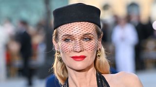 Diane Kruger is seen with a red lip and wearing a black hat whilst attending Vogue World: Paris 2024 at the Place Vendome on June 23, 2024 in Paris.
