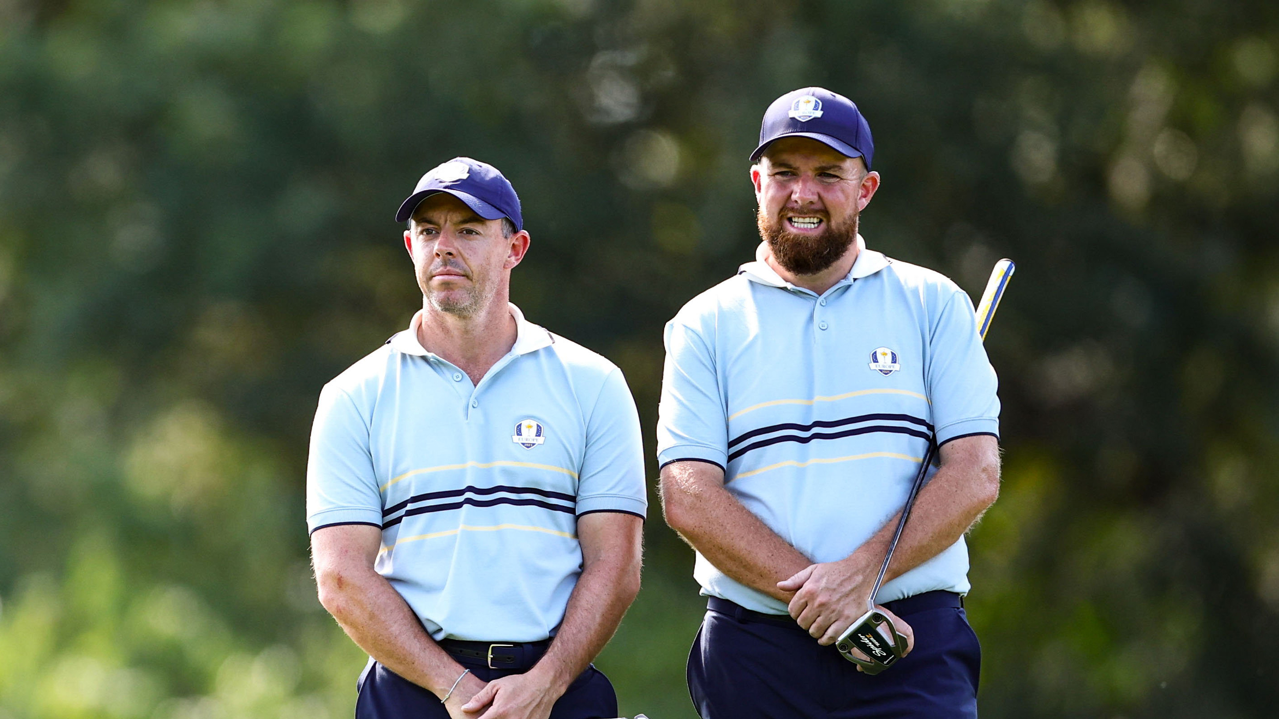 Rory McIlroy and Shane Lowry stand side by side during the Friday fourball session of the 2025 Ryder Cup